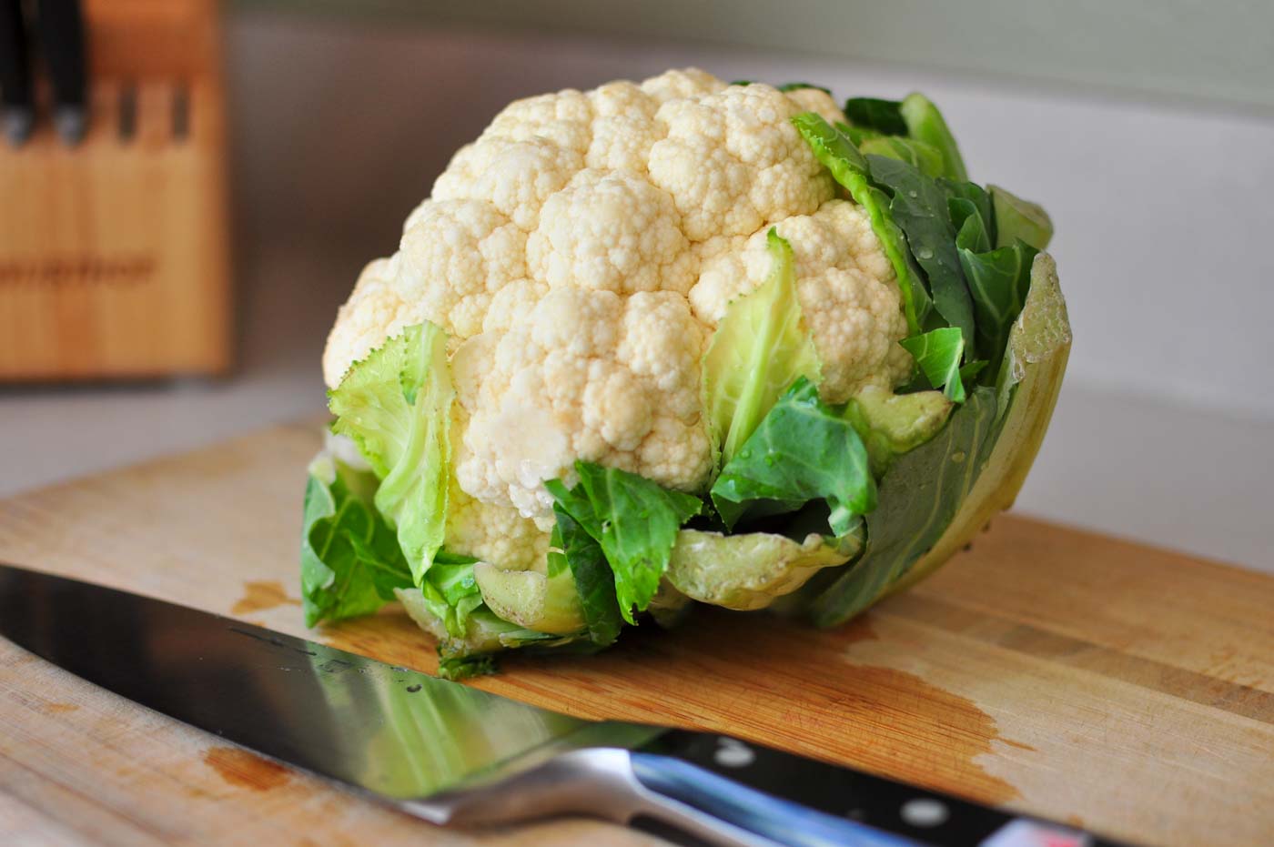 Fresh head of cauliflower on a cutting board